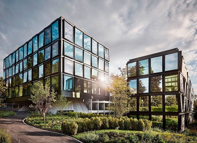Two modern office buildings and gardens from Helvetia